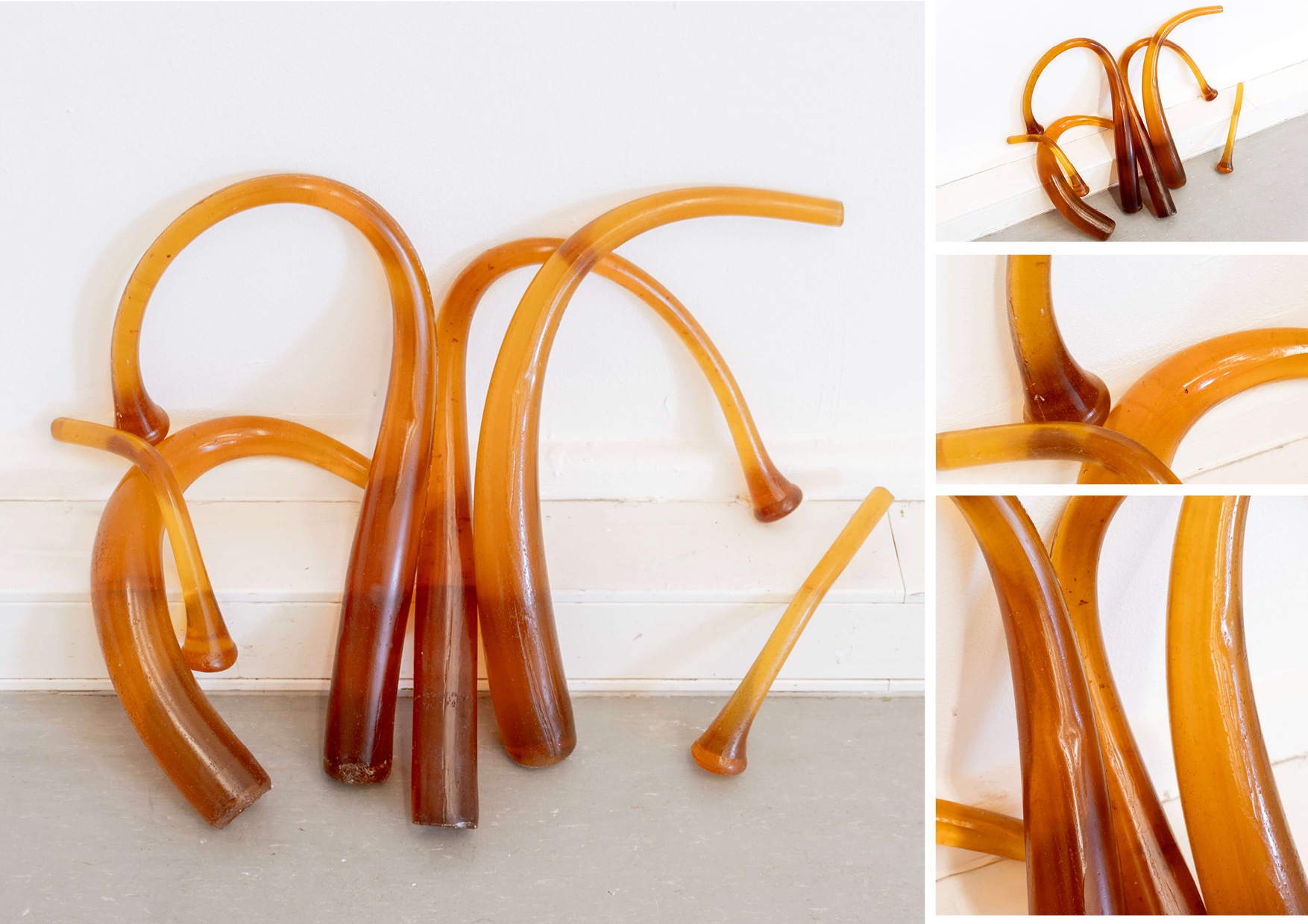 4 gelatin cast baseball bats leaning against wall